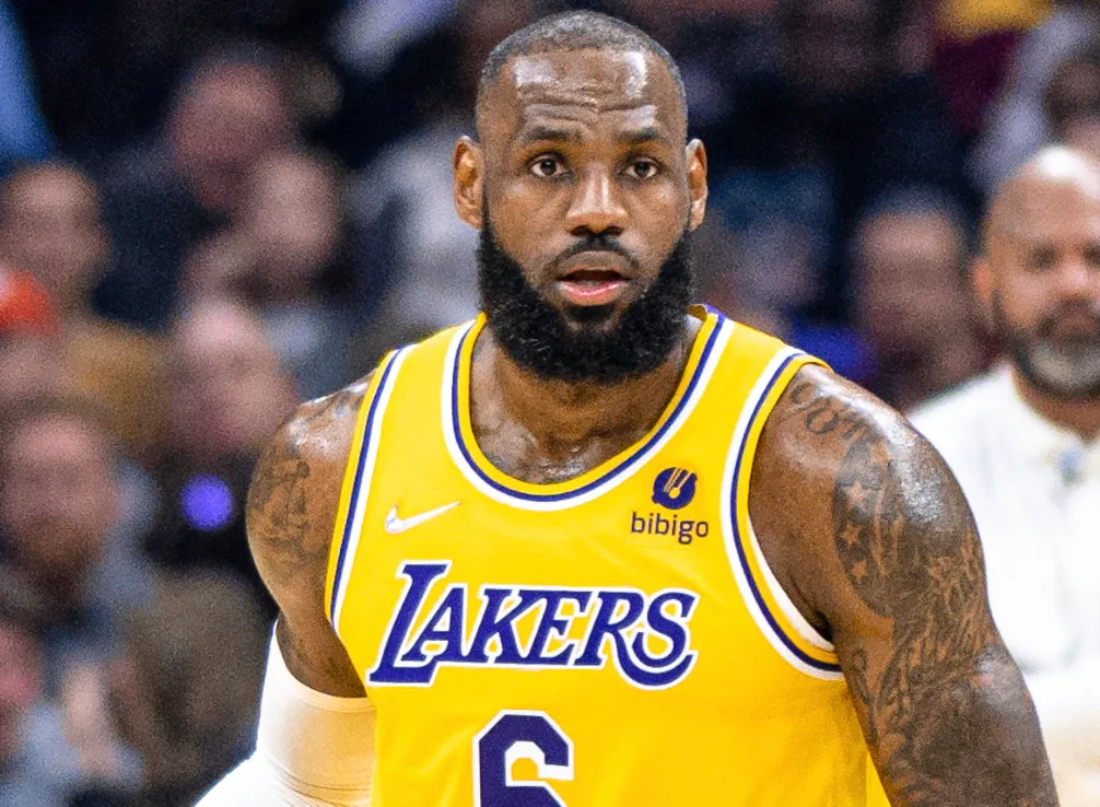 LeBron James in a yellow Lakers jersey, looking intently, with Michael Jordan as a related topic.
