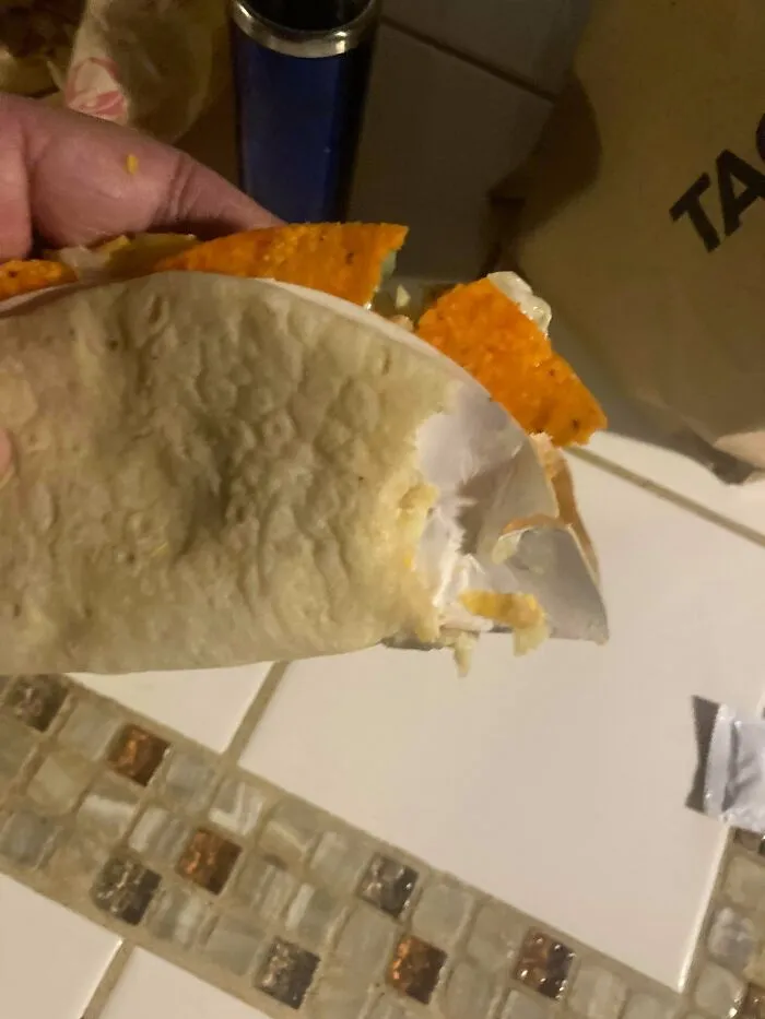 Taco with a dorito shell wrapped in paper, weird food combos served together