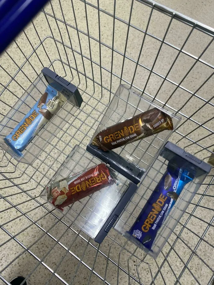 Individual protein bars sealed inside plastic security cases, forming questionable food combos for sale.