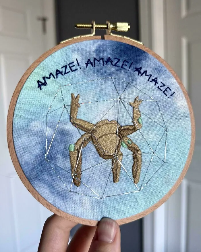 Embroidery project featuring a crab in a geometric shape with the words Amaze Amaze Amaze