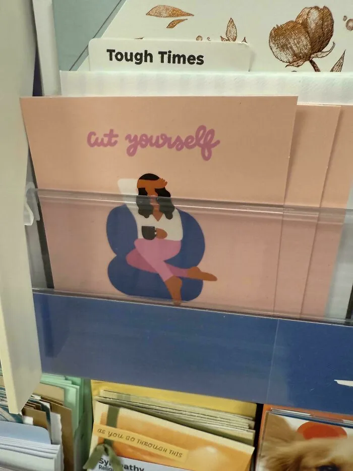 Card design fail showing greeting card with confusing 'cut yourself' message