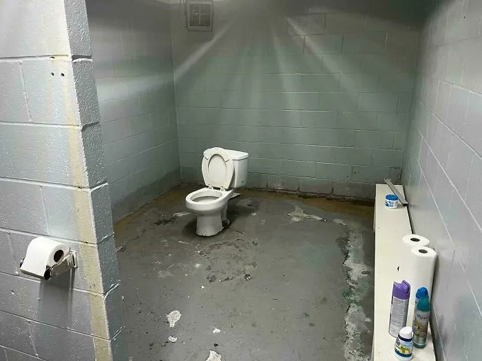 Dilapidated bathroom with a poorly maintained toilet showing design fail