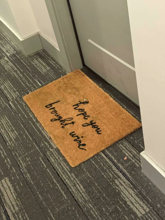 Doormat reading hope you brought wine awkward placement design fail