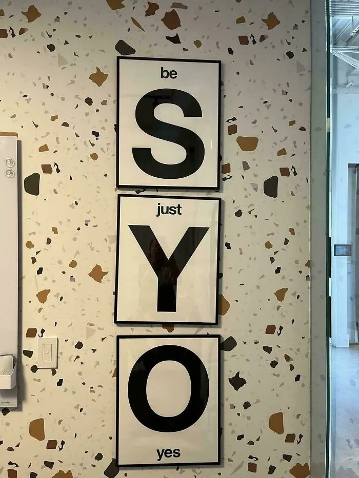 Wall art layout with framed letters spelling SYO creating odd design fail