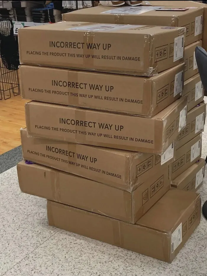 Stacked boxes labeled incorrect way up design fail