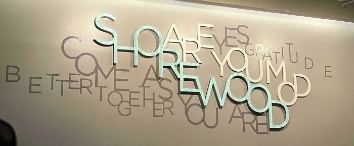 Awkwardly layered wall text with overlapping letters creating confusing design fail