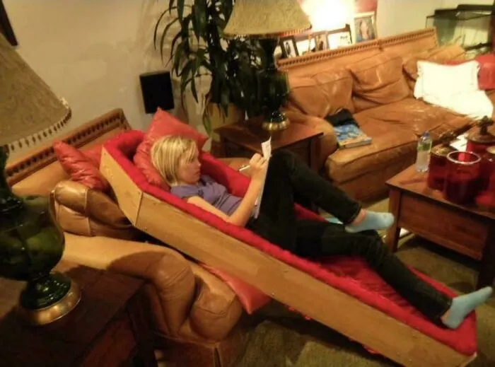 A young woman relaxing in a coffin-shaped lounge chair, showcasing a unique parenting style from her amazing father.