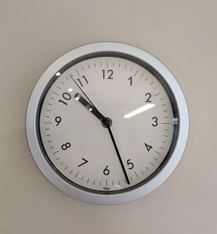 Wall clock showing incorrect time due to misplaced hour and minute hands
