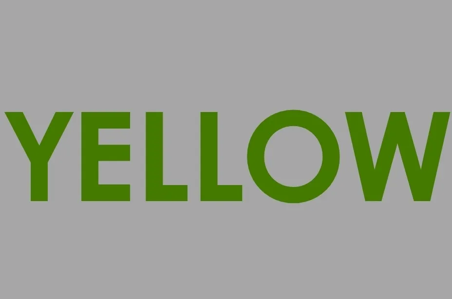 The word YELLOW written in the color green on a gray background, a playful color test.