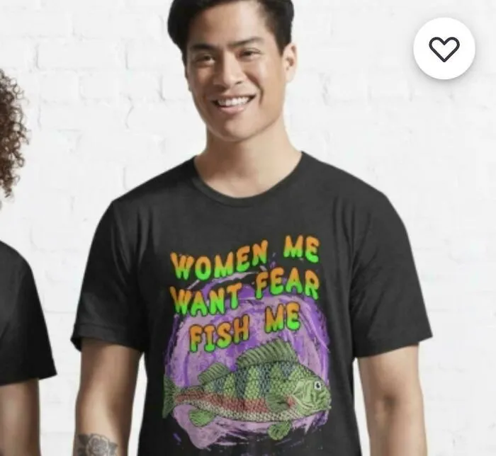 A man wearing a black T-shirt with the text WOMEN ME WANT FEAR FISH ME and a fish graphic, a truly bad clothing design.