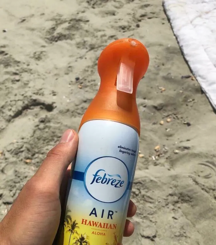An amazing father uses Febreze Air Hawaiian on a sandy beach.