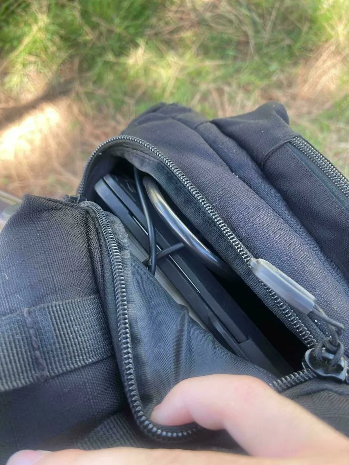 Backpack That Has Zippers On The Bottom Leading To The Main Bag That Open Up Automatically When You Put Too Much In