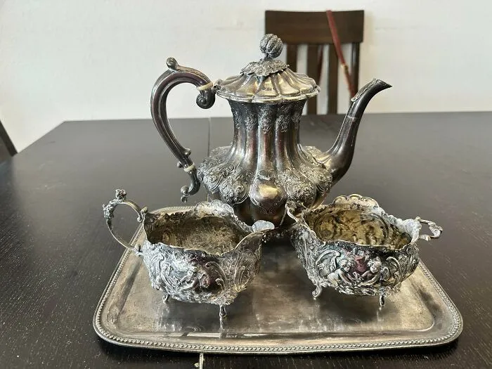 Ornate silver tea set on a matching tray, an old treasure discovered by antique lovers