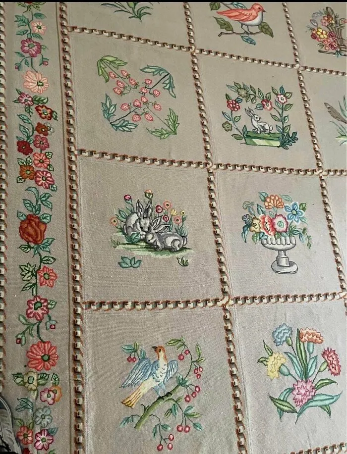 Detailed embroidered quilt panels featuring floral patterns and rabbits among antique lovers treasures
