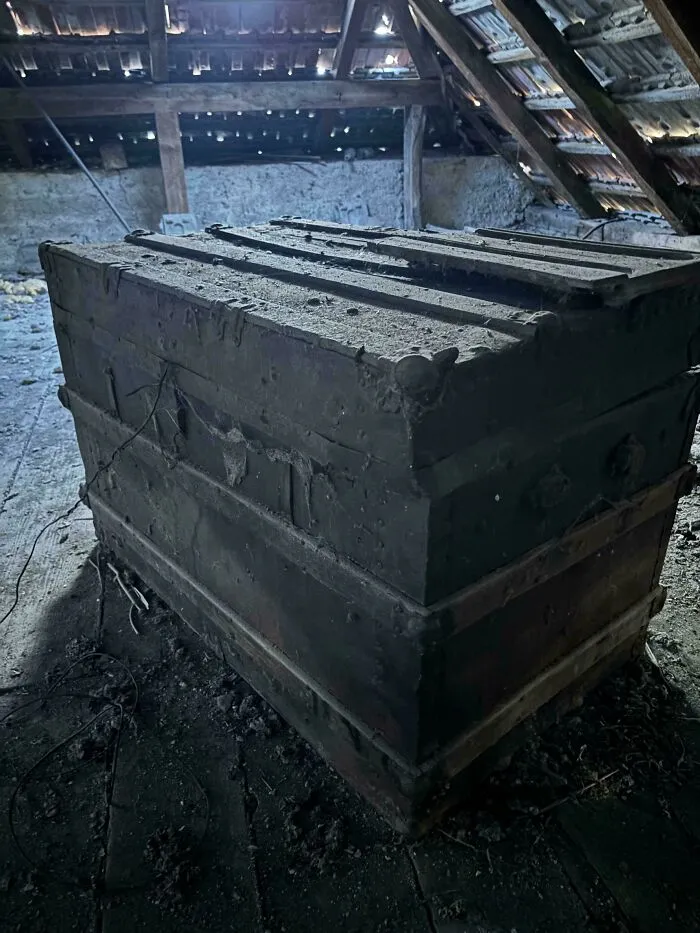 Large weathered wooden trunk, one of many old treasures discovered in an attic.