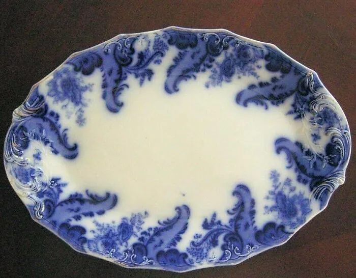 Blue and white vintage ceramic platter discovered by antique lovers.