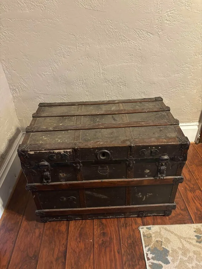 Large vintage wooden trunk with metal latches, a classic piece among old treasures for antique lovers.