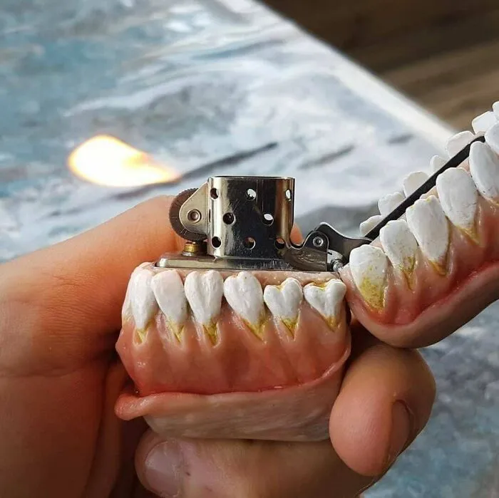 A lighter encased in realistic-looking fake teeth and gums as a questionable DIY project