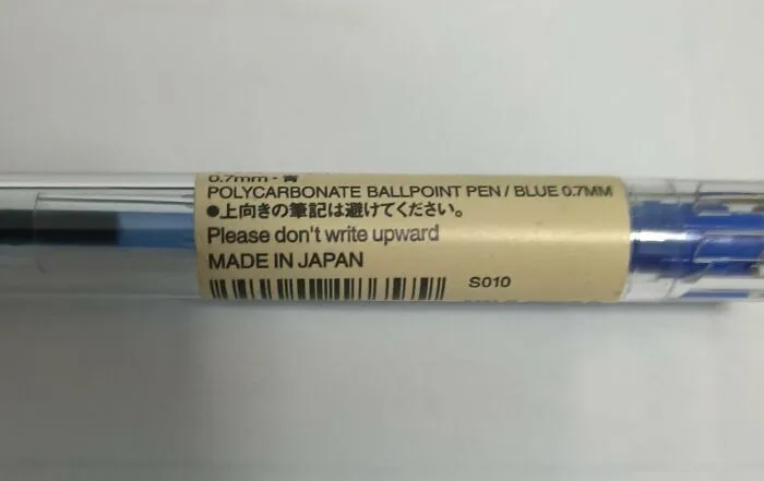 A close-up of a blue polycarbonate ballpoint pen with a label that says Do not write upward, part of the Not Interesting Community.