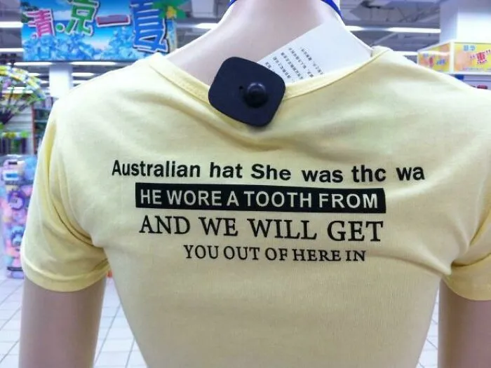 Yellow t-shirt on a mannequin with grammatically incorrect and nonsensical English text, featuring bad clothing designs.
