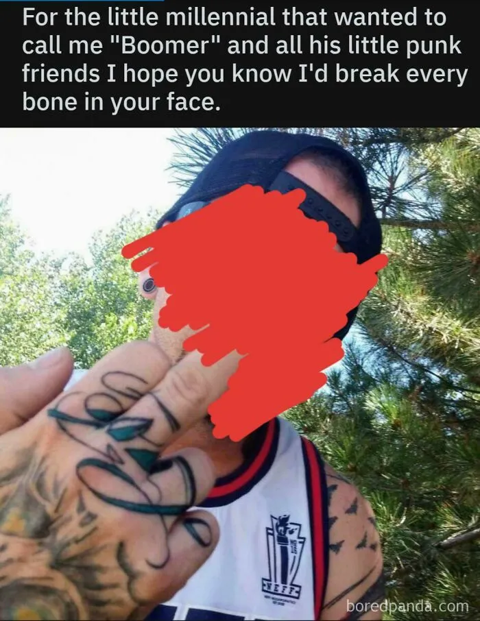 Man with tattoos flipping middle finger threatening millennials acting tough