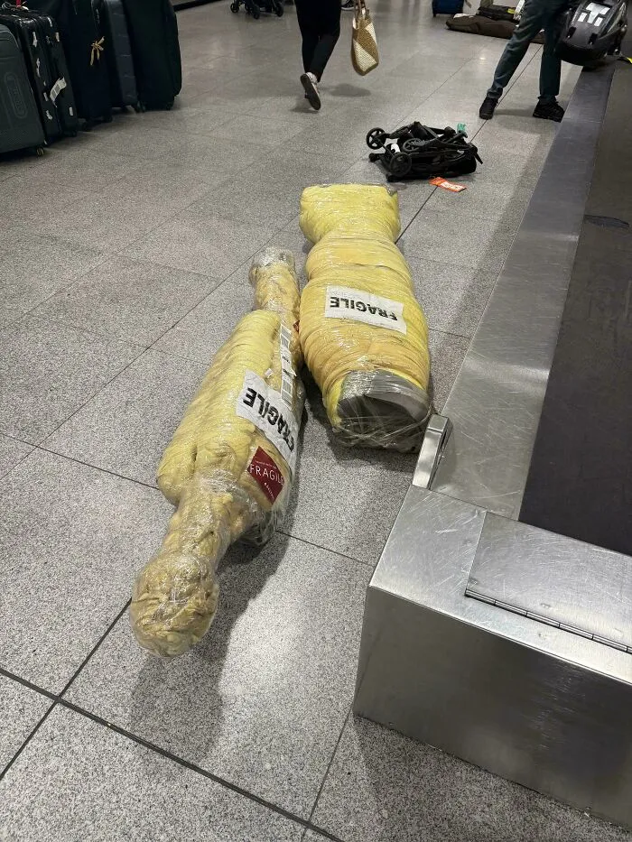 6 Foot Long Heavy Strangely Wrapped Fragile Packages Waiting In Baggage Claim At Airport