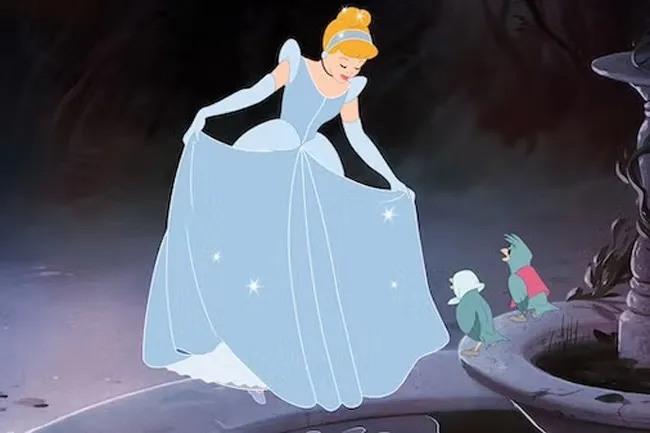 Cinderella, in her sparkling blue gown, looks down at her bird friends beside a stone fountain. Animated movie nostalgia.