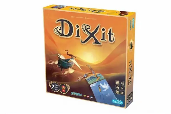 Dixit board game box. The main colors are orange and yellow. A boat and whimsical elements are on the cover.