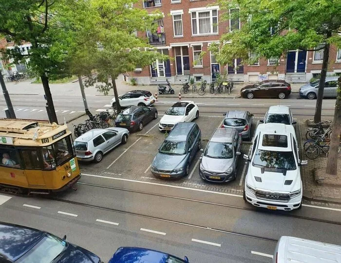 An American Ram Truck Designed For Suburbs Trying To Fit Into A Typical European Parking Space, Showing Just How Ridiculously Large They Are