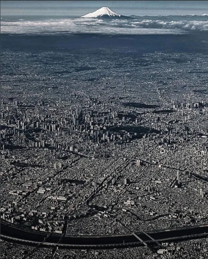 Aerial view of dense urban cityscape with Mount Fuji in background urban hell