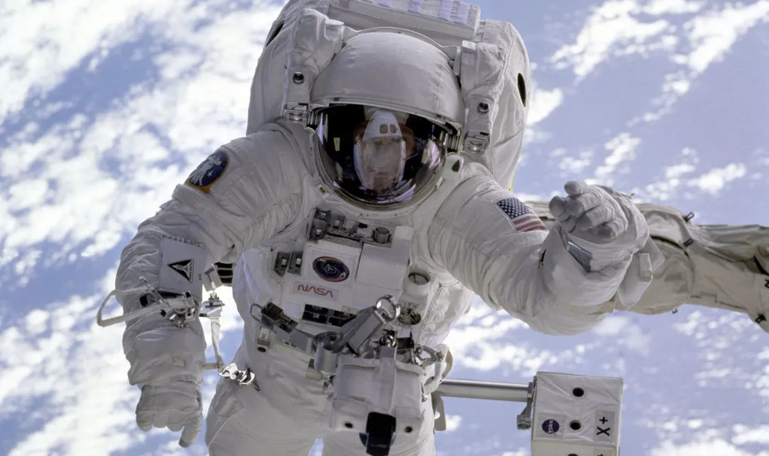 Astronaut in a white suit, with clouds below. Science general knowledge quiz question: Why do astronauts appear weightless?