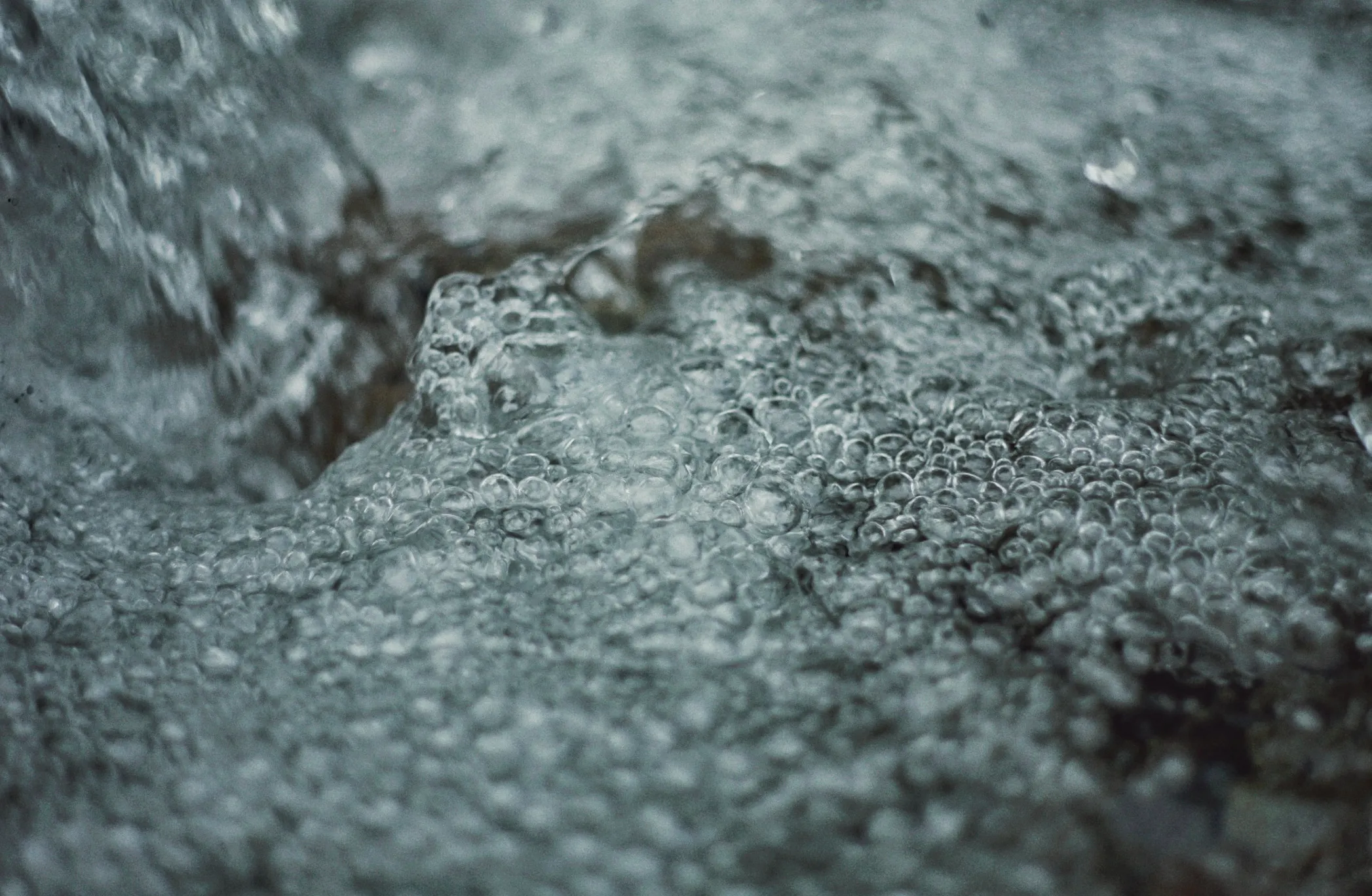 A close-up of clear water bubbling and swirling, illustrating the boiling point of water. Part of a general knowledge quiz.