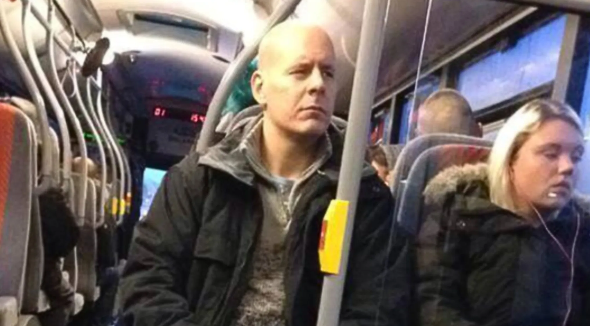 A bald man in a black jacket riding a bus, who does this person look like? Celebrity doppelgangers.