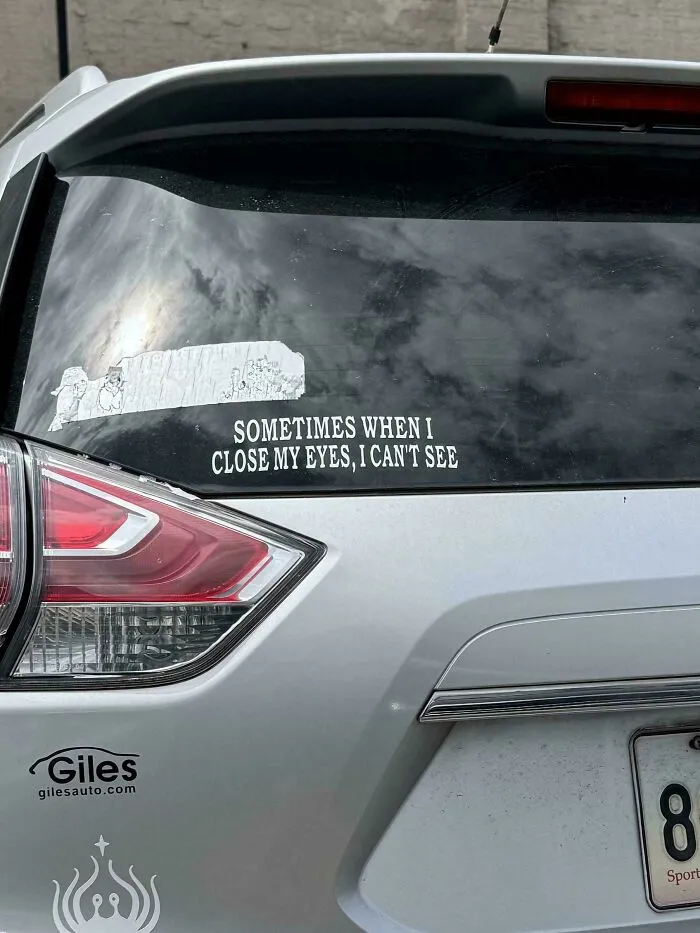 Funny bumper sticker on a white car reads, Sometimes when I close my eyes, I can't see.