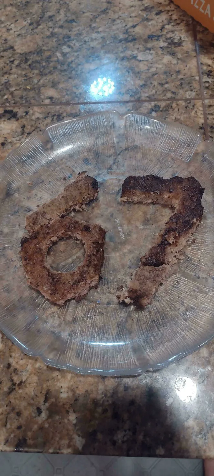 Burger patties shaped into the number 67 as a questionable food combo served on a plate.