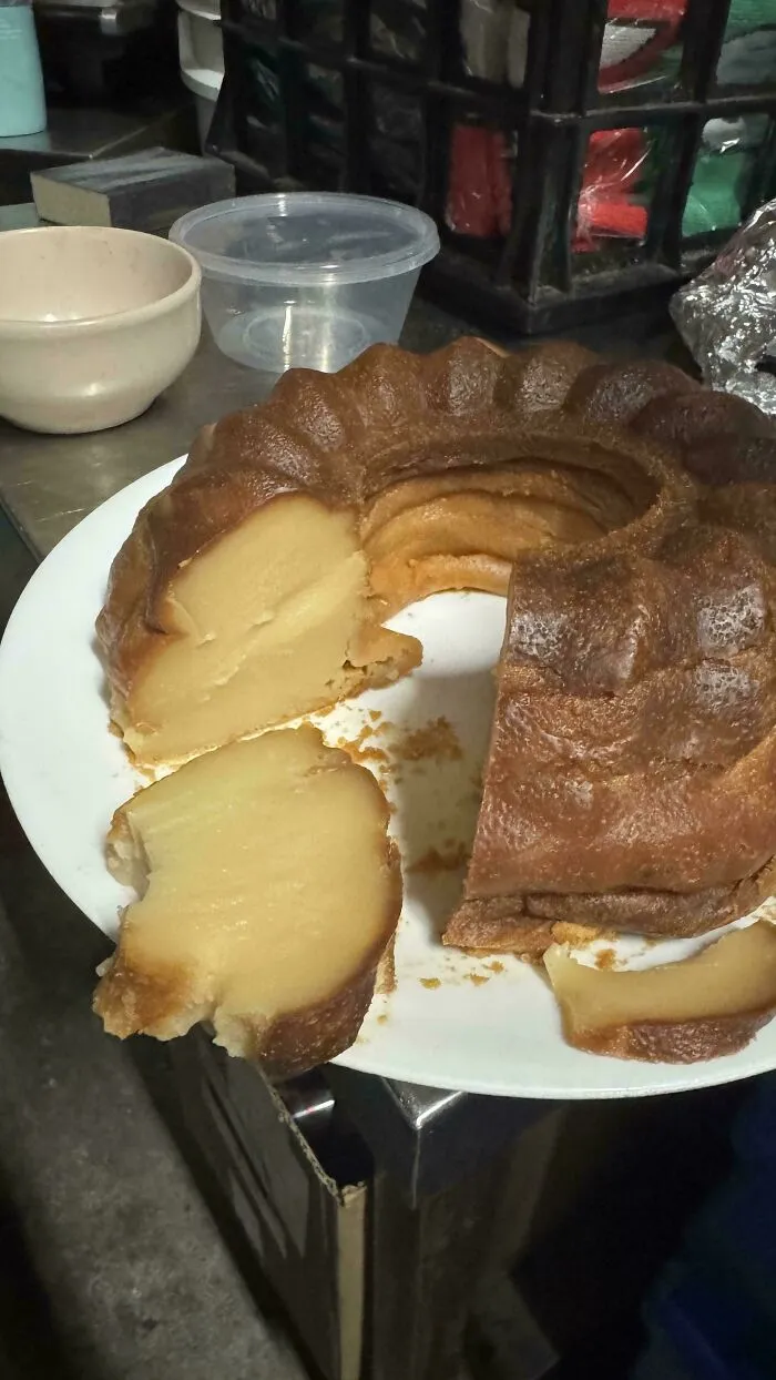A sliced golden-brown baked treat on a white plate, showing its delicious texture. Bakers creation.