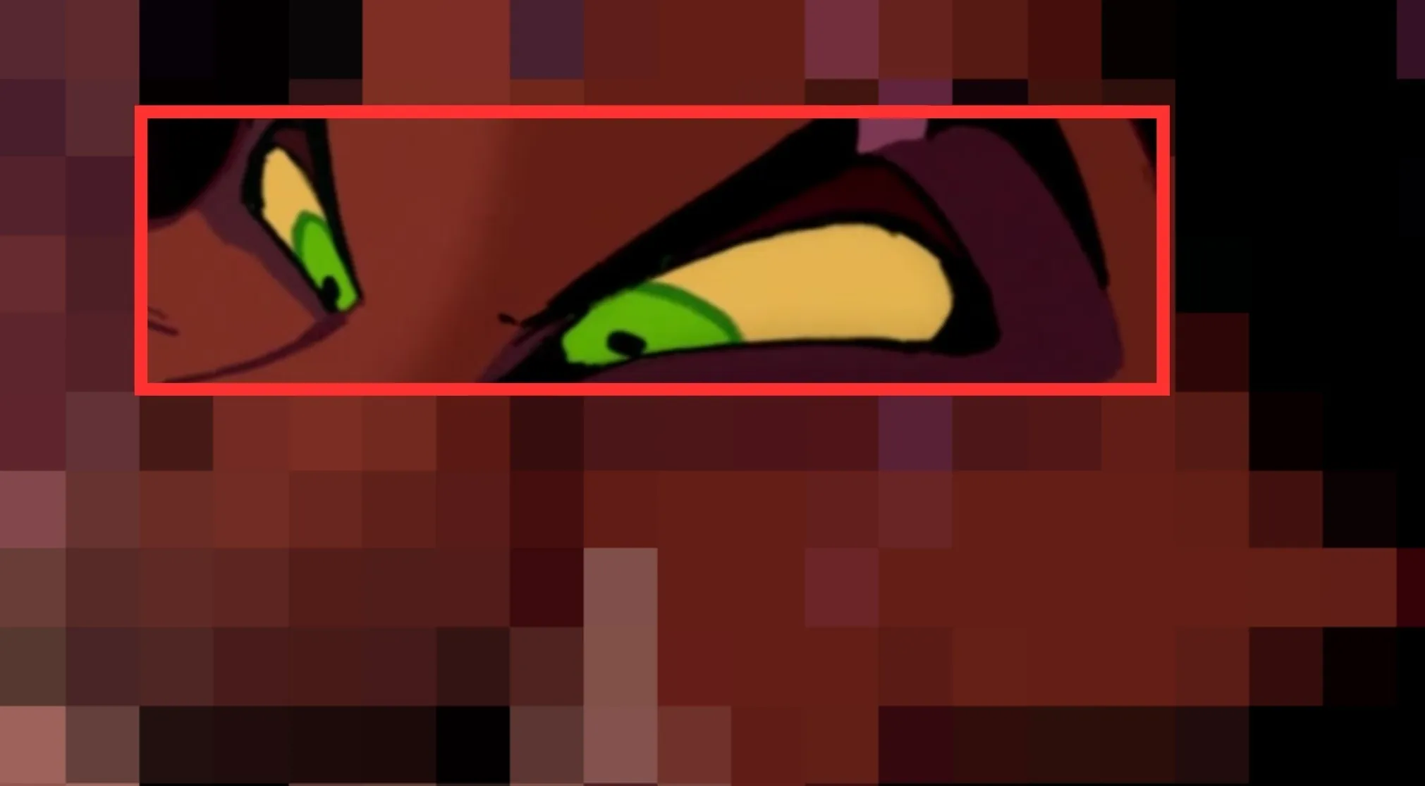 Close-up of animated Disney characters eyes with green irises and yellow sclera, framed in a red rectangle.