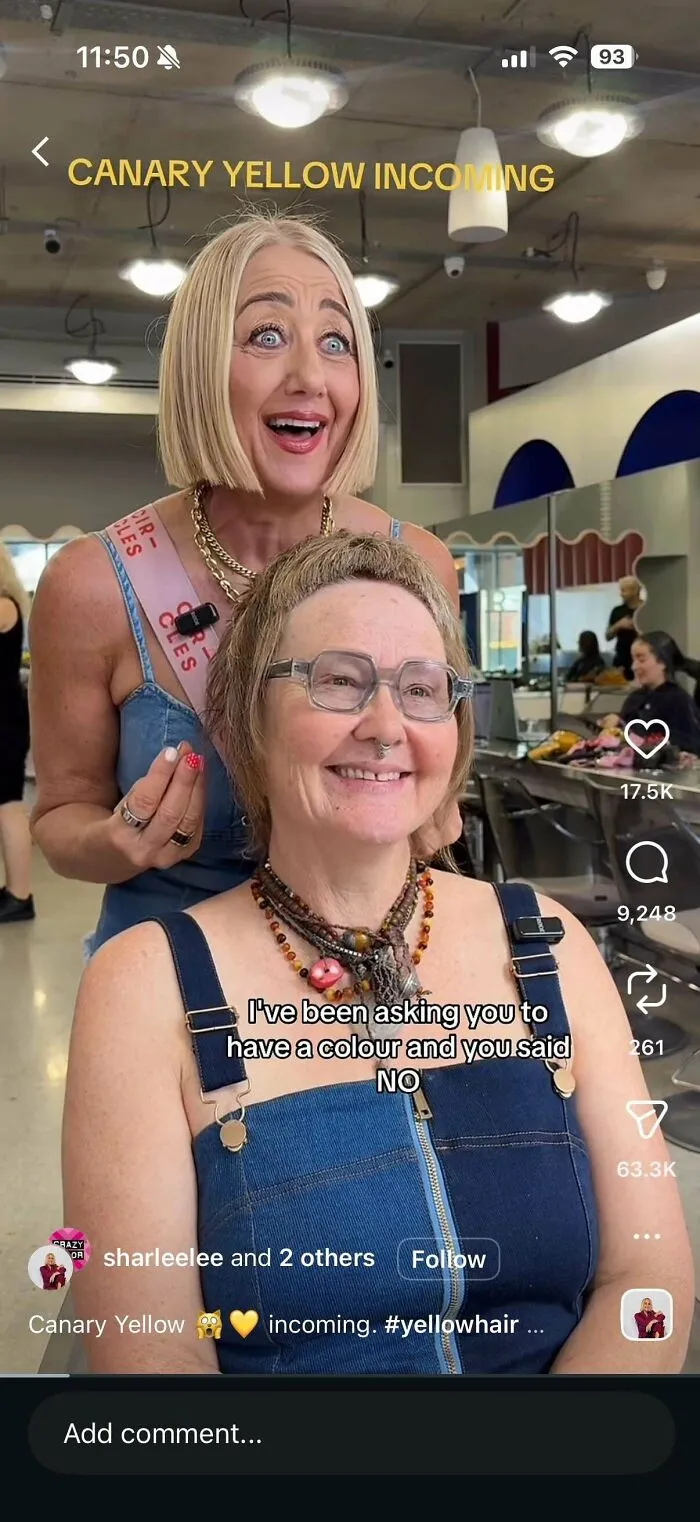 Two women at a hair salon, one excitedly gesturing towards the other, who has a smile, illustrating a hair salon disaster.