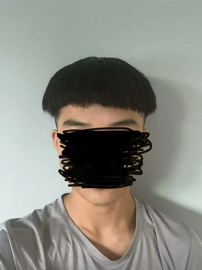 Man with a very short, round bowl cut, a prime example of a hair salon disaster.