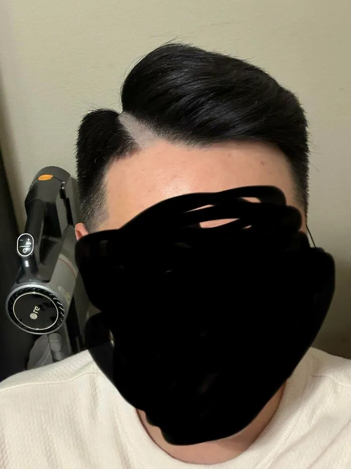 Man with a sharp side part and fade, illustrating a hair salon disaster.