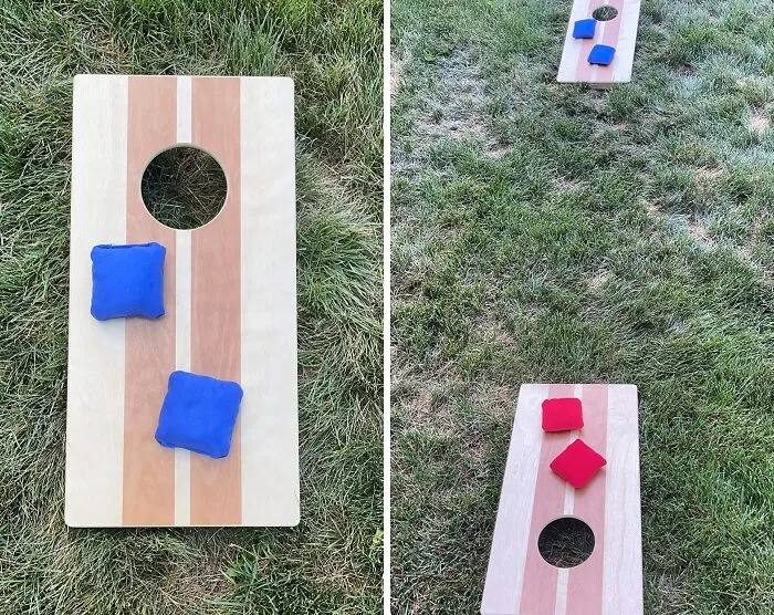 Outdoor cornhole game boards with bean bags on grass, classic father's day gift idea