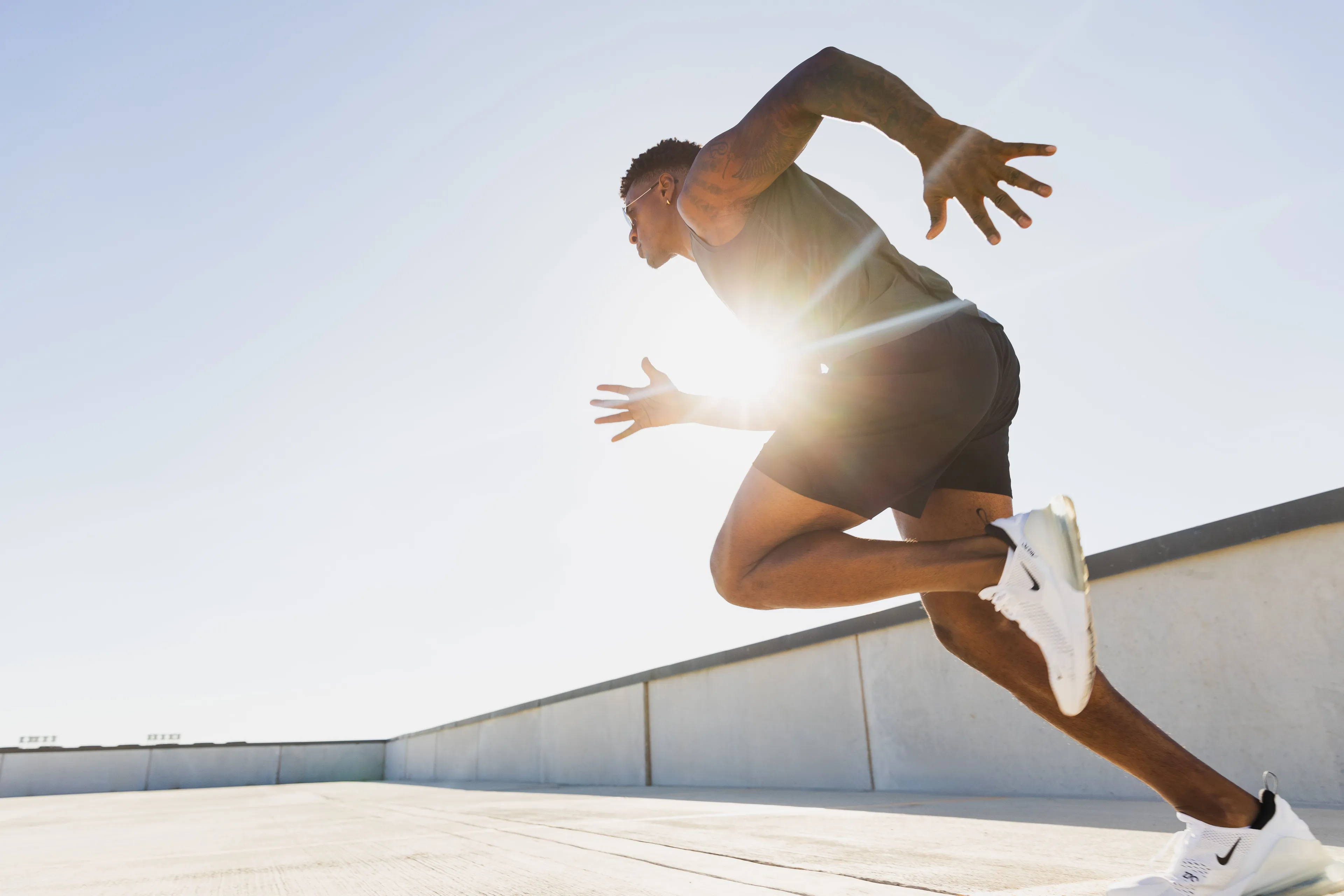 An athlete demonstrates super speed, mid-stride during a run on a sunny day, embodying the superpower.