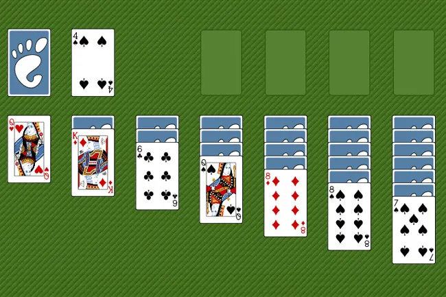 A classic game of Solitaire in progress, with cards arranged on a green background. Several stacks show face-up cards like a King of Diamonds and a Queen of Spades, along with face-down cards and empty foundation piles.