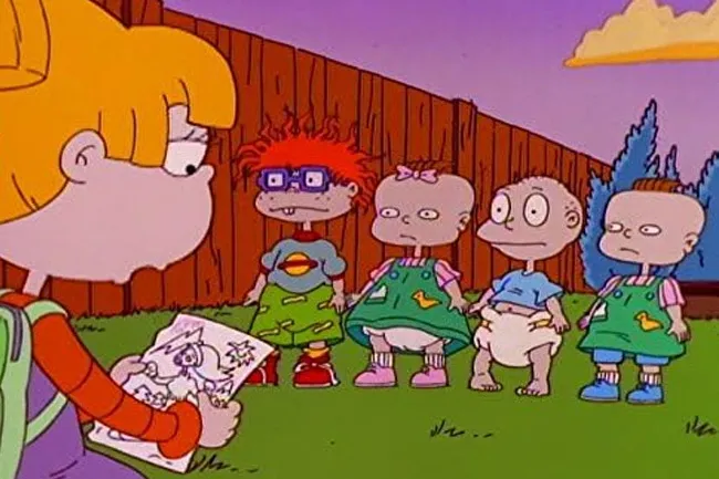 Angelica Pickles shows a drawing to Tommy, Chuckie, Phil, and Lil in this iconic Rugrats scene.