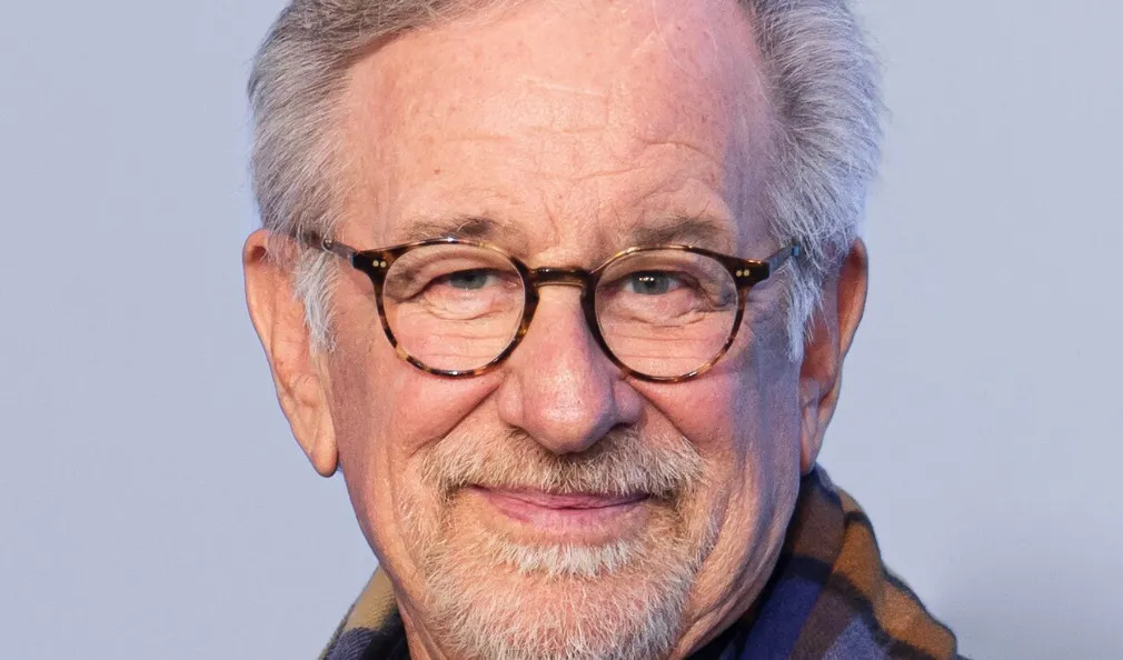Close-up of Steven Spielberg wearing glasses, smiling slightly. Test your Pop Culture knowledge in our A to Z quiz.