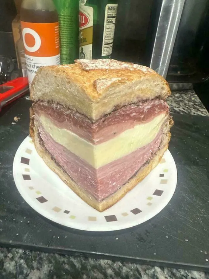 An unusually thick sandwich cut into a heart shape representing questionable food combos.