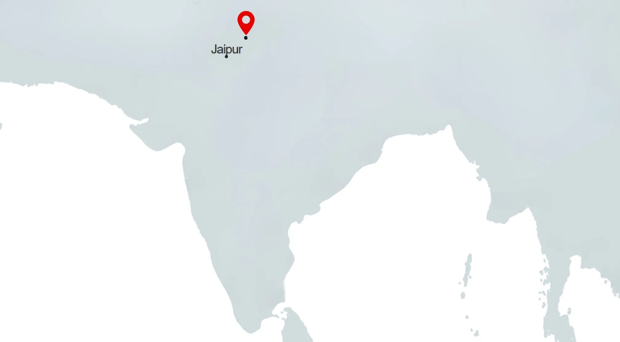 A map of India with a red pin marking Jaipur. Guess the capital from a borderless map.
