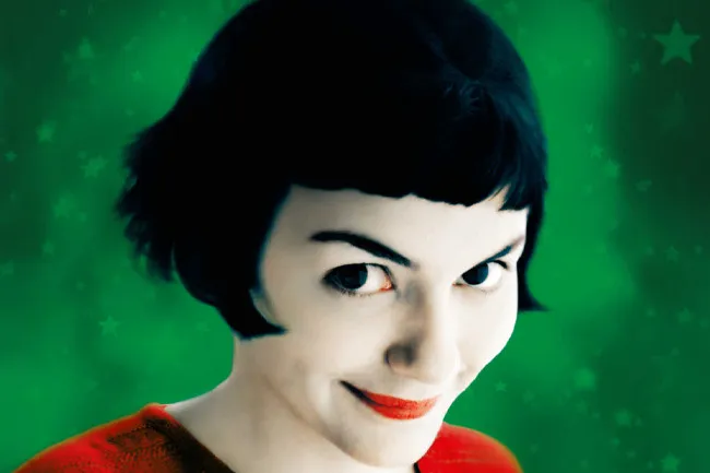 A close-up of Amélie with a mischievous smile, a still from the film Amélie, great for a movie night alone.
