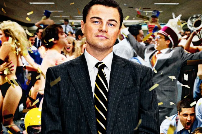 The Wolf of Wall Street movie still with Leonardo DiCaprio surrounded by celebrating people and confetti.