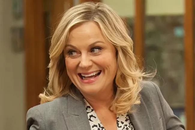 A smiling Leslie Knope from Parks and Recreation, a fictional character for company when you can't sleep.